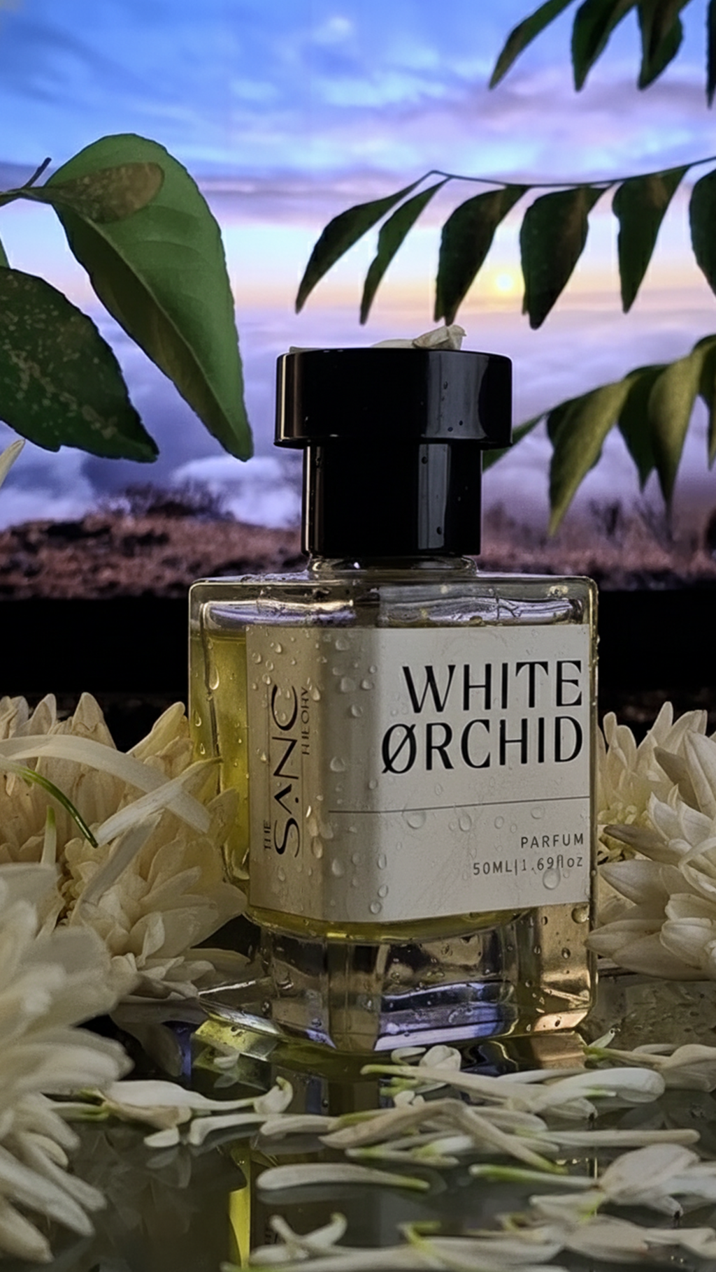 The Sanc Theory White Orchid perfume bottle with water droplets placed in a floral arrangement at golden hour.